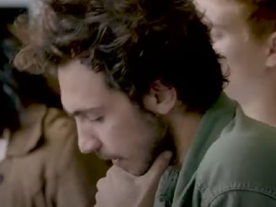 Barney Harris has his hands on his chin as he is reading the paper.